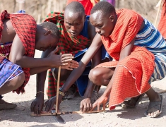 Maasai men are making a fire