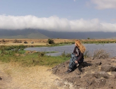 Eva is sitting on the rocks in crater Ngorogoro