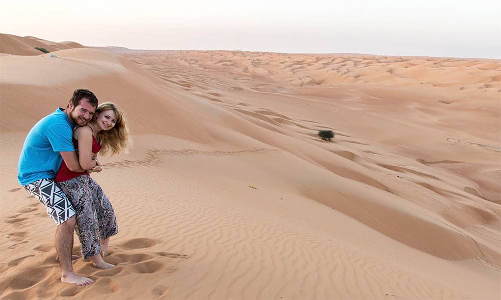 Eva & Toma at the top of dunes in desert Wahiba Sands in Oman