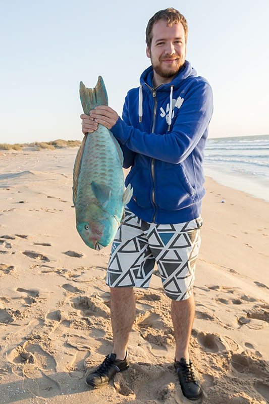 Tom with fresh fish on beach in Oman