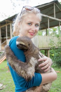 Eva cuddles with the sloth