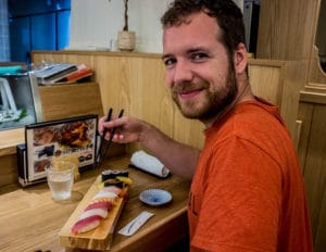 Tom eating sushi